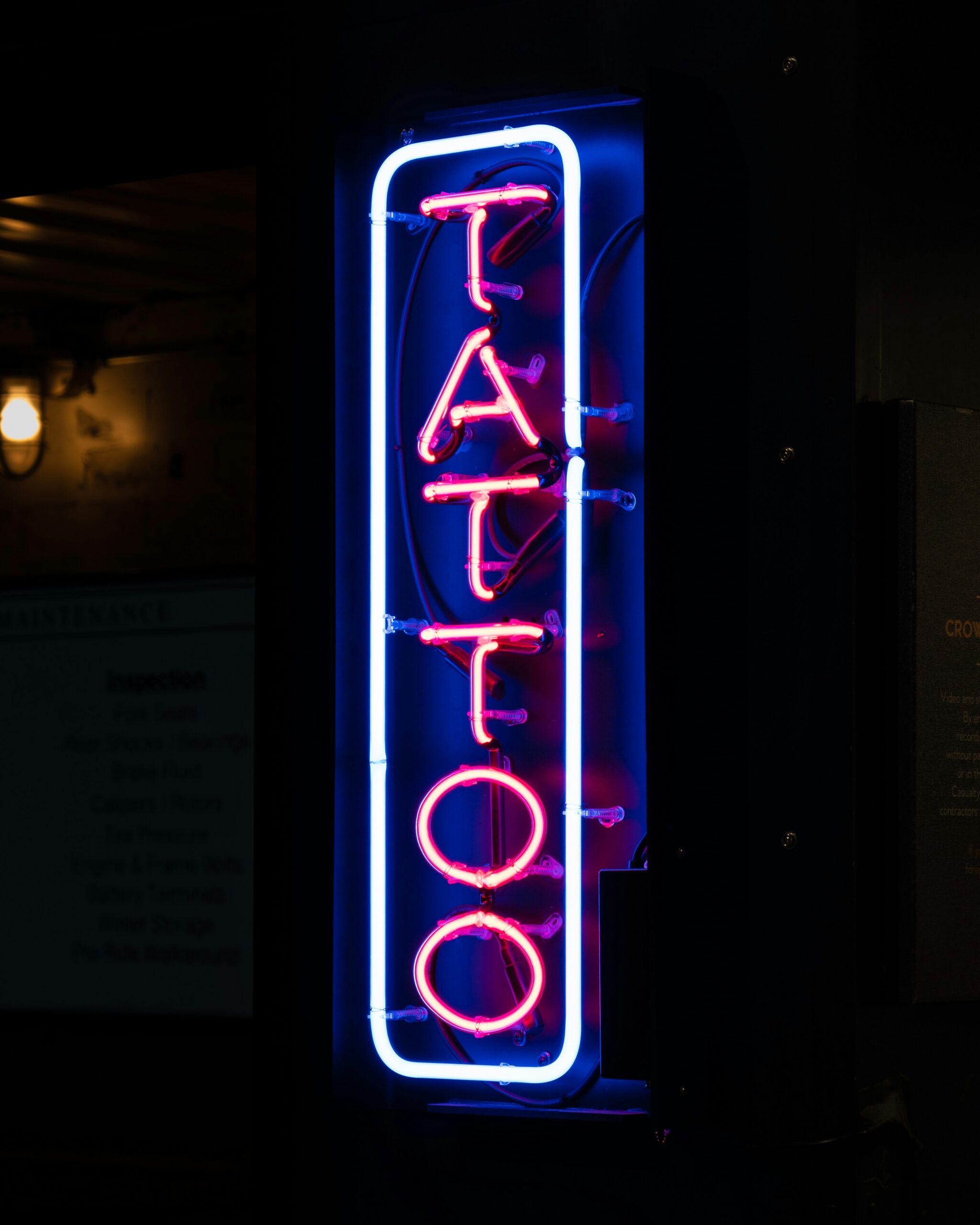 Neon "TATTOO" sign in vibrant blue and red, representing Spa City Ink's tattoo artistry and inviting atmosphere in Hot Springs, Arkansas.